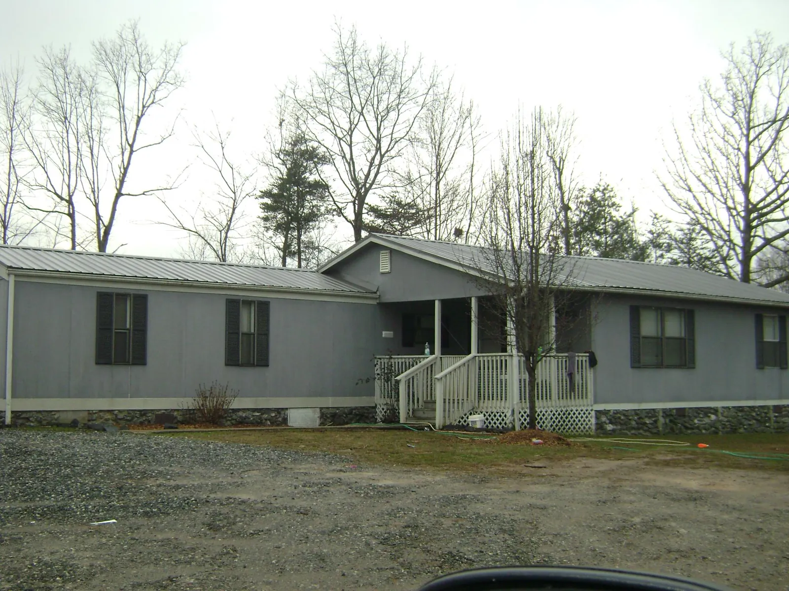 Metal roof over a manufactured home with a covered front porch in Butler
